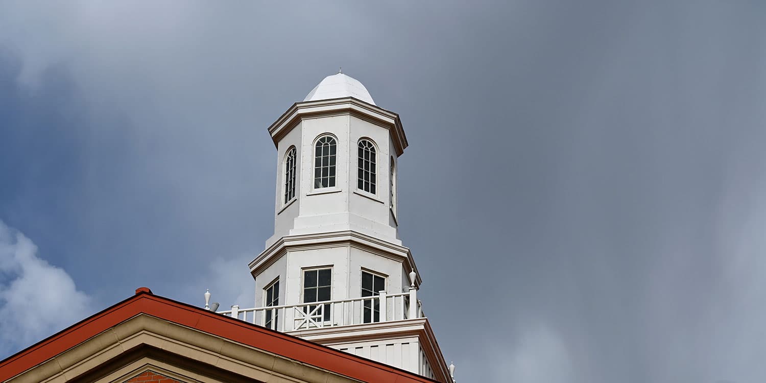 Adams State University Richardson Hall cupola with stormy clouds