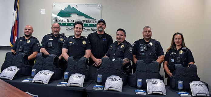 standing behind their personal, high-performance body armor, left to right: Adrian Cordova, Jamie Coulson, Davis Gonzales, Shield616 Founder and President Jake Skifstad, Chief Sam Maestas, Nate Rael, and Chasity Winchester.