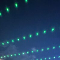 2025 Adams State University Homecoming Downtown Alamosa Bonfire green lights strung across street
