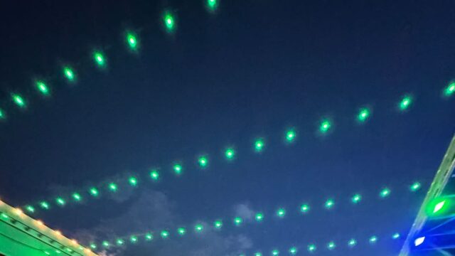 2025 Adams State University Homecoming Downtown Alamosa Bonfire green lights strung across street