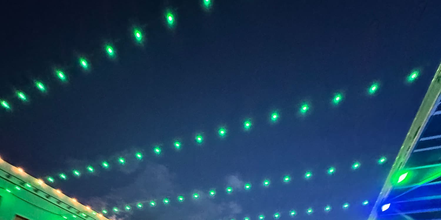 2025 Adams State University Homecoming Downtown Alamosa Bonfire green lights strung across street