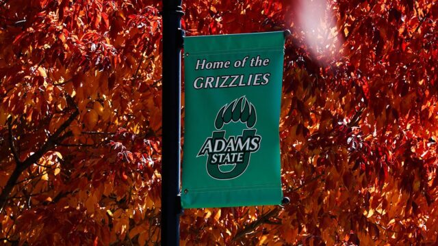 Adams State University campus autumn leaves and banner home of the grizzlies